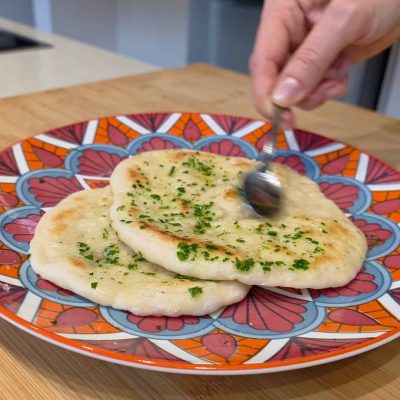 il pane naan senza glutine viene cosparso do olio e prezzemolo
